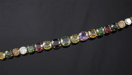 A gold and multi coloured gem bracelet, 6.75in.